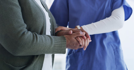 People, holding hands and caregiver in nursing home, healthcare and medical assistance or compassion. Nurse, kindness and support for elderly patient with illness, helping and empathy for senior careの写真素材