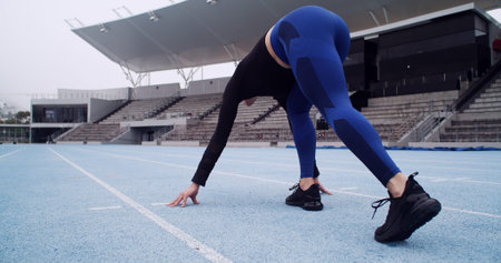 Starting line, track and back of woman in stadium for running, practice or training for competition....