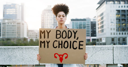 Woman, protest and portrait for pro choice sign, announcement and call to action for support in city. Girl, board and poster for freedom, reproductive autonomy and human rights for parenthood in USAの写真素材