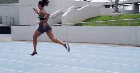 Running, speed and fitness with woman on race track for cardio challenge, health or competition....