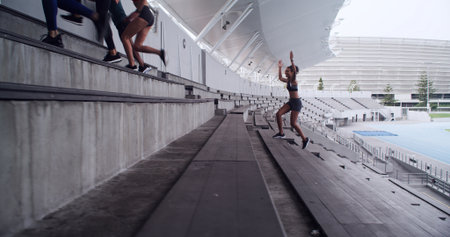 Running, drills and team with people on stadium steps for workout, fitness and support. Training exercise, cardio challenge and sports athlete with group of friends on stairs for marathon practiceの写真素材