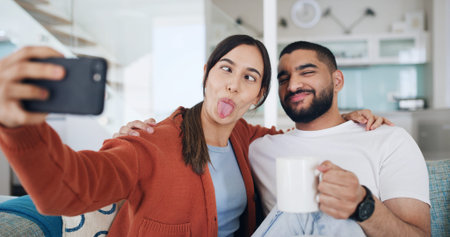 Couple, selfie and funny face on sofa, home and happy for hug, care and coffee for post on web....