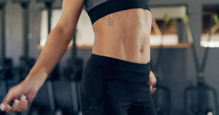 Abs, person and skipping with rope gym for fitness, exercise routine and cardio training. Athlete, woman and jump with equipment for endurance, physical workout and sports performance for wellnessの写真素材