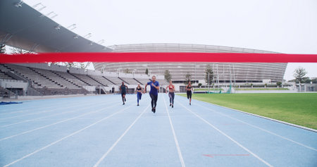 Event, finish line and people on track for running, sports challenge or cardio fitness. Outdoor, athlete sprinter or healthy runners in stadium for training, exercise or contest in competition arenaの写真素材