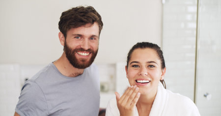 Lotion, portrait and smile with couple in bathroom of home together for moisturizing routine....