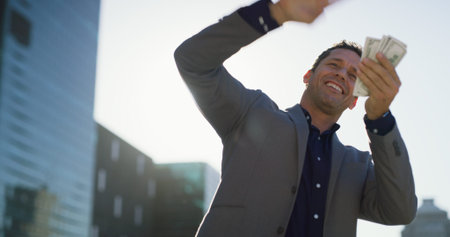 Businessman, excited and money rain in city for salary, earnings and career promotion. Mature...