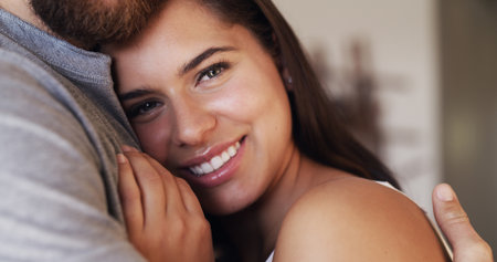 Woman, couple and hug for love and portrait with smile, trust and commitment in marriage. Care, comfort and connection with people in embrace for bonding, romance and security in healthy relationshipの写真素材