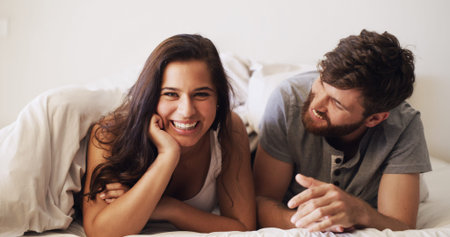 Couple, portrait in bed and relax with happiness, moment and connection for bonding in home. Woman,...