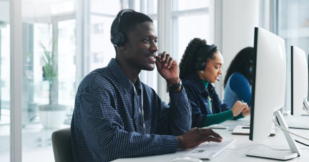 Call center, agent and man with headset, listen and consultation for sales, tech or lead generation. Telemarketing, coworkers and person with mic for communication, services and chat with contactの写真素材
