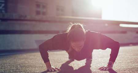 Outdoor, push ups and woman on road, fitness or workout routine for core strength, healthy and city....