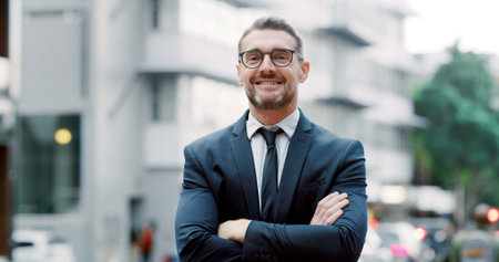 Happy, city and portrait of businessman with crossed arms for urban development, real estate and career. Professional, worker and person for town planning, commercial building and property growthの写真素材