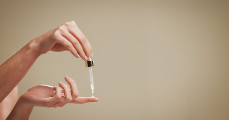 Beauty, serum and hands of person in studio for hyaluronic acid, skincare and anti aging. Mockup...