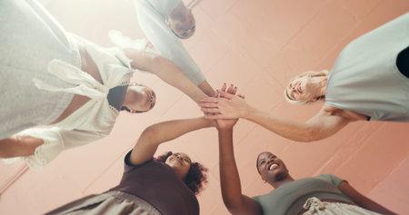 Below, hands stack and women with fitness, support and motivation with health club. Low angle, group...