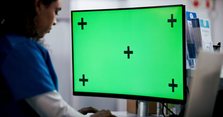 Computer, green screen and medical with nurse in hospital for file update or typing report....