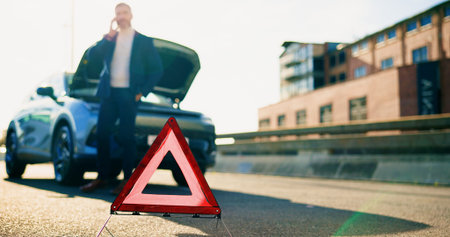 Warning sign, car breakdown and man on road with problem, fail or roadside assistance. Frustrated,...