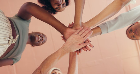 Fitness, hand stack and motivation with woman friends in studio together for pilates class from...