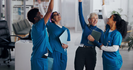 Team, celebration and medical people in hospital for success, healthcare mission and happiness. Health, medicine and group of nurses with director for professional community, cheers and collaborationの写真素材