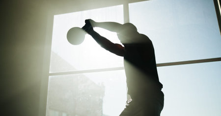Fitness, man and workout with kettlebell in gym for health, wellness or power with flare....