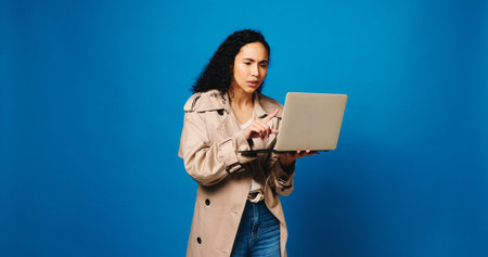 Laptop, reading and woman fashion designer in studio for market research of trendy style on space....