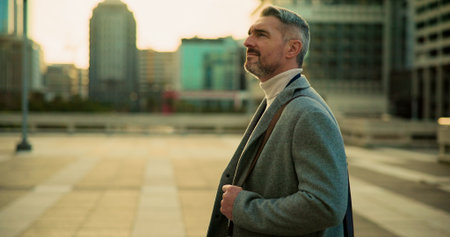 Business, thinking and man in street, ideas or urban town with morning commute, calm or thoughtful. Mature person, outdoor or travel with decision, choice or journey with company future or profileの写真素材