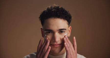 Moisturizer, skincare and portrait of man in studio for beauty, natural or facial glow. Cosmetic,...