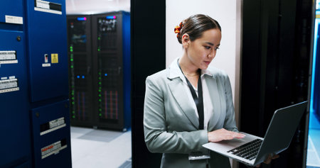 Laptop, typing and woman in data center for cybersecurity, network maintenance or programming....