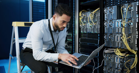 Online, cybersecurity and man with laptop, typing and check server performance and network engineer....