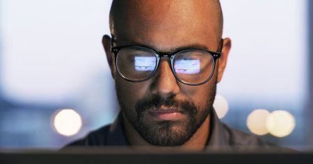 Night, laptop and man with glasses, office or research for troubleshooting, online or cybersecurity....