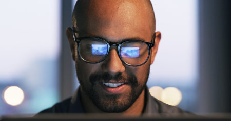 Online, laptop and man with glasses, office or research for troubleshooting, cybersecurity or night....