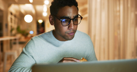 Fast food, laptop and web designer with business man in office at night for coding or programming at...