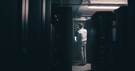 Technician, back and inspection with man in server room for cybersecurity, network and system...