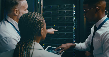 People, programming and tablet in server room, teamwork and engineering with hardware upgrade. IT...