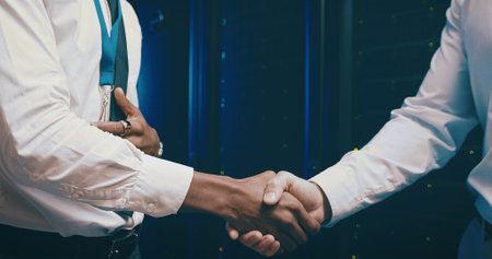 Agreement, handshake and meeting with people in server room for network administration deal....