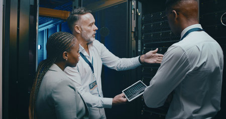 People, cyber security and tablet in server room, conversation and teamwork with engineering. IT...