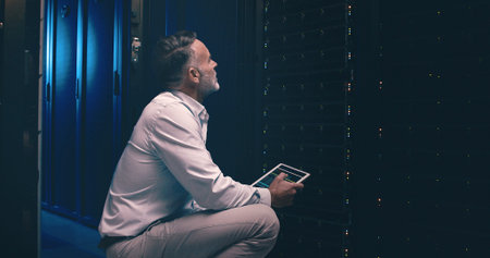 Tablet, inspection and technician or man in server room for cyber security, software update or...