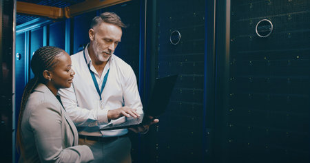 Cybersecurity, laptop and problem solving with people in server room together for network upgrade....