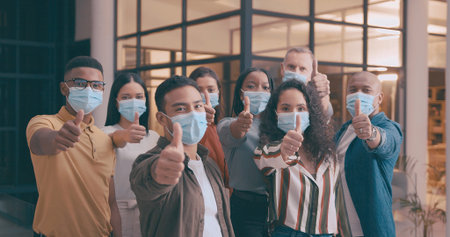 Thumbs up, portrait and business people with face mask in office for social distance, meeting and...