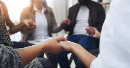 Support group, people and holding hands for therapy, praying and help in community center....