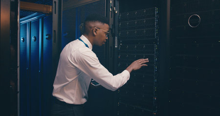 Black man, tablet and inspection in server room with cybersecurity, system and hardware check....
