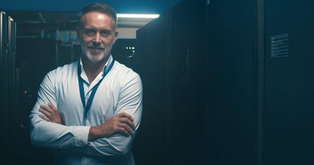 Arms crossed, portrait and cybersecurity with man in server room for data center, network or...