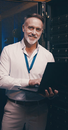 Laptop, portrait and database with man in server room for data center, network or systems....