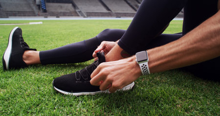Hands, shoes and tie with person on field in stadium for start of cardio training, fitness or...