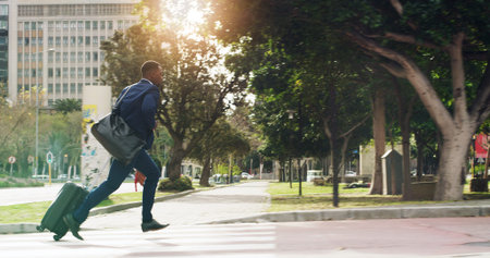 Business, city and black man running late with luggage for travel, urban commute and journey....