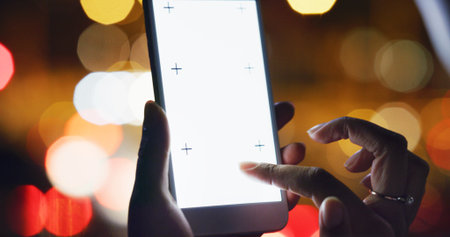 Hands, person and phone screen in city at night for texting, social media and bokeh for travel....