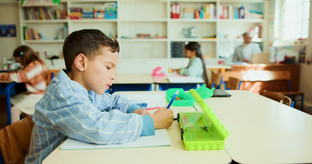 Education, child and writing in classroom for learning, lesson and creativity with stationery. Kid,...