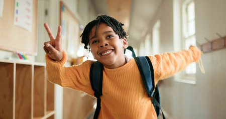 Education, peace sign and smile of black child in school corridor for development, learning or...