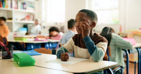 Thinking, writing or boy in classroom for learning education, test paper or solution with students....