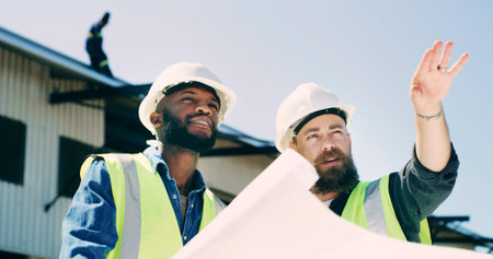 Construction, team and men on worksite with blueprints, consultation and guidance for quality...