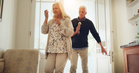 Senior couple, door and home with ice cream for dessert, date or bonding together in retirement....