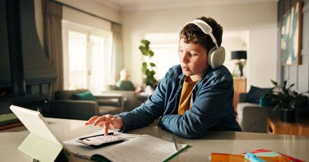 Homework, tablet and boy with headphones, calculator and elearning with book, studying and maths....